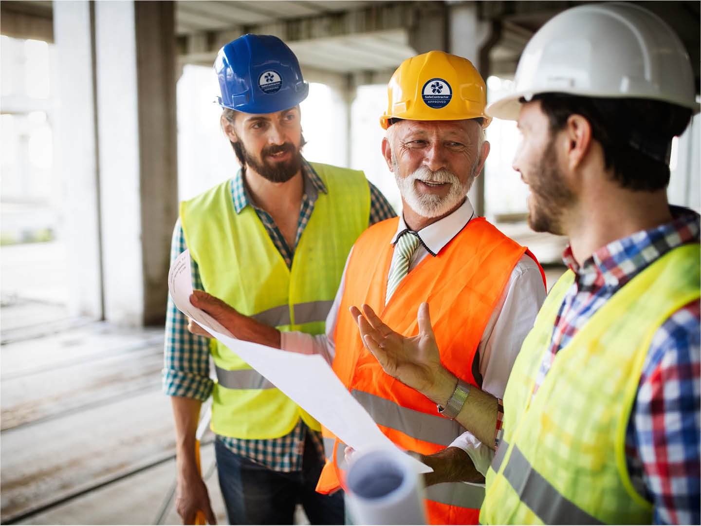 Contractors in Kuwait branded three men discussing in hard hats